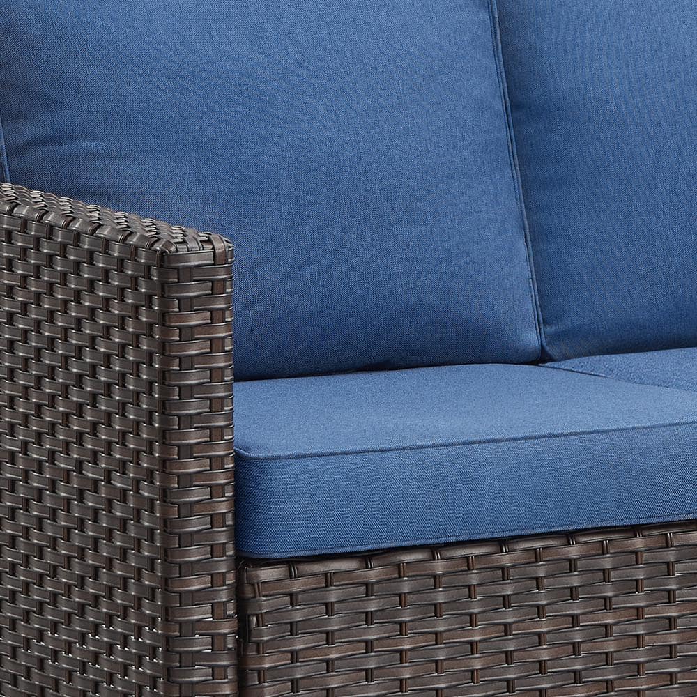 Close-up of the blue cushion and brown wicker armrest.