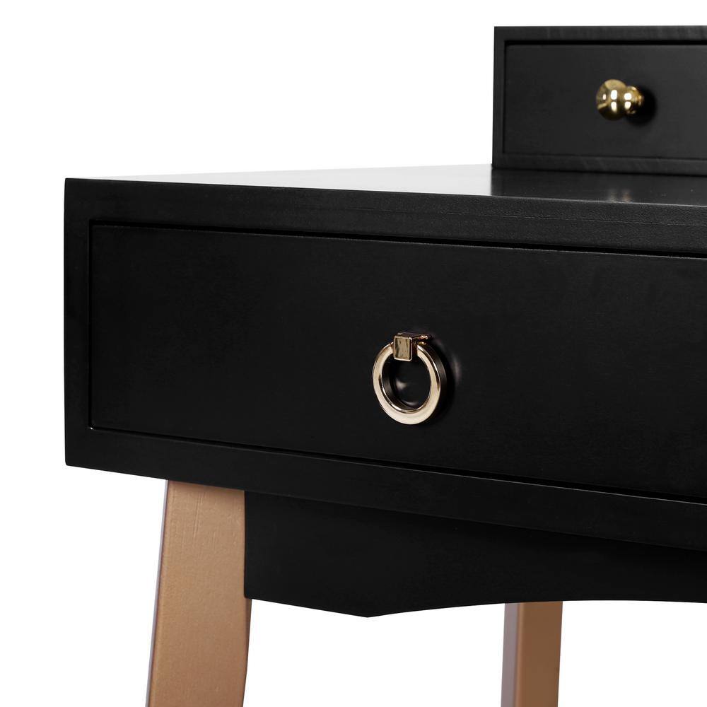 Close-up of a black vanity drawer with a gold ring handle.