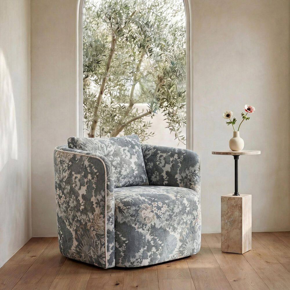 Cosimo blue floral armchair in a bright room with a window.