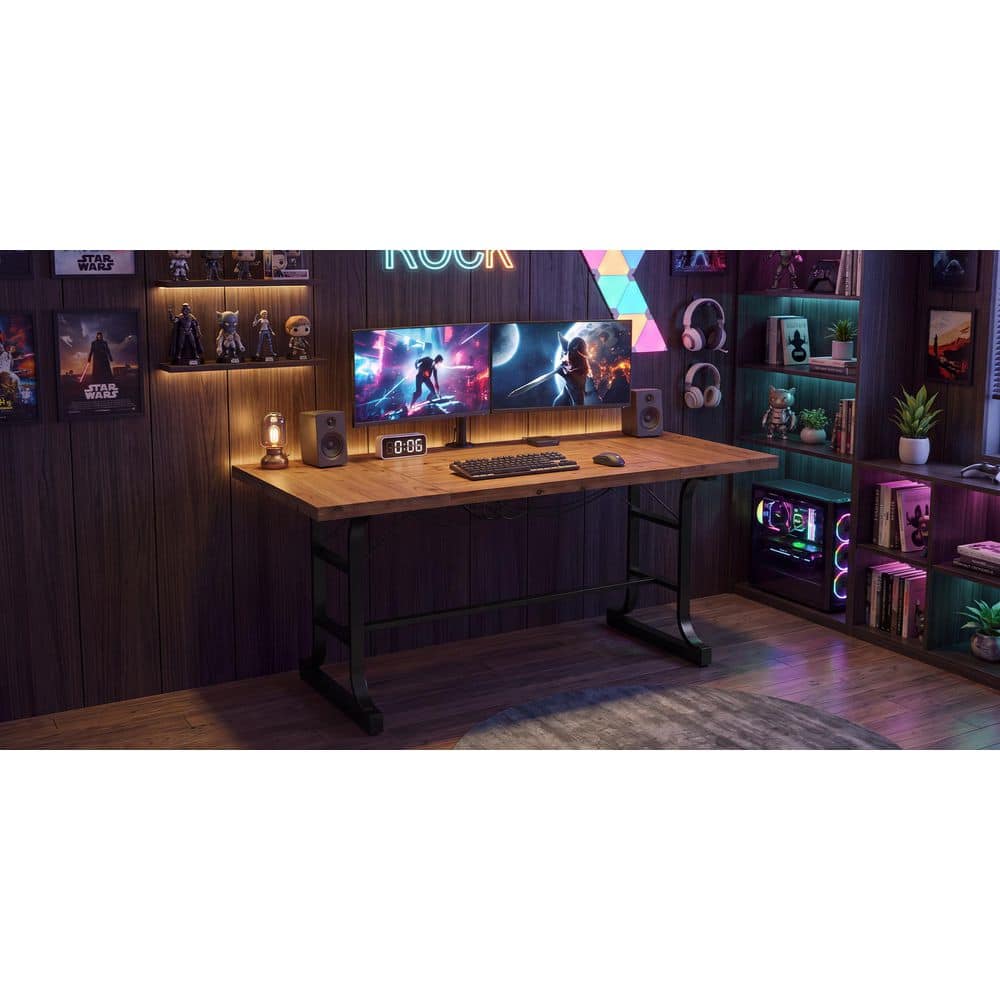 Computer desk in a room with dark wood paneling.
