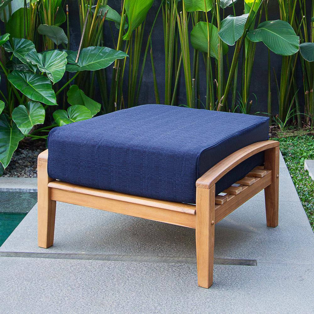 Cambridge Casual Torrey teak outdoor ottoman with navy blue cushion.