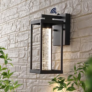 Juno 4.75 in. Black Hardwired Outdoor Cylinder Sconce Iron/Seeded Glass with Dusk-to-Dawn Sensor Integrated LED 1-Light
