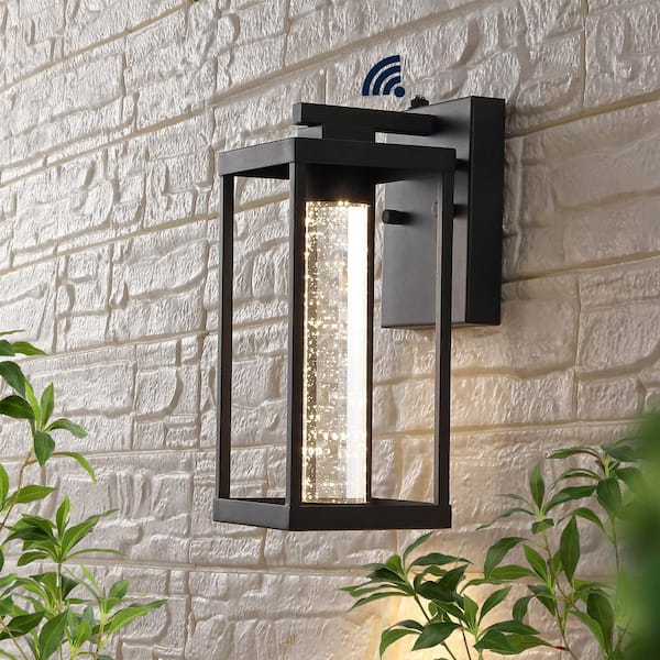 JONATHAN Y Juno 4.75 in. Black Hardwired Outdoor Cylinder Sconce Iron/Seeded Glass with Dusk-to-Dawn Sensor Integrated LED 1-Light