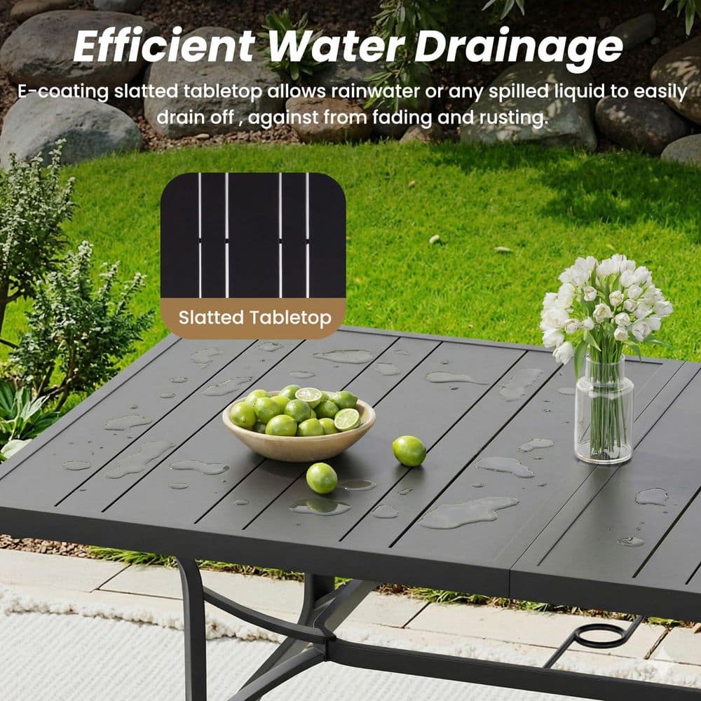Close-up of the slatted black metal tabletop with water droplets.