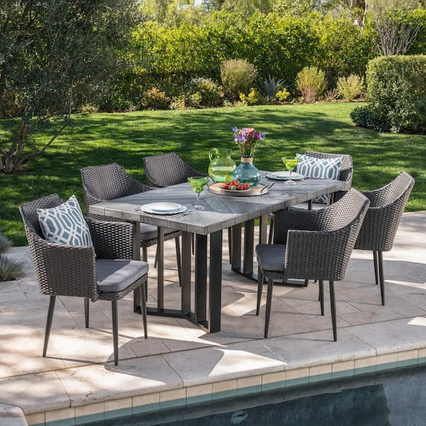 Noble House Zander Grey 7-Piece Faux Rattan Rectangular Outdoor Dining Set with Grey Cushions