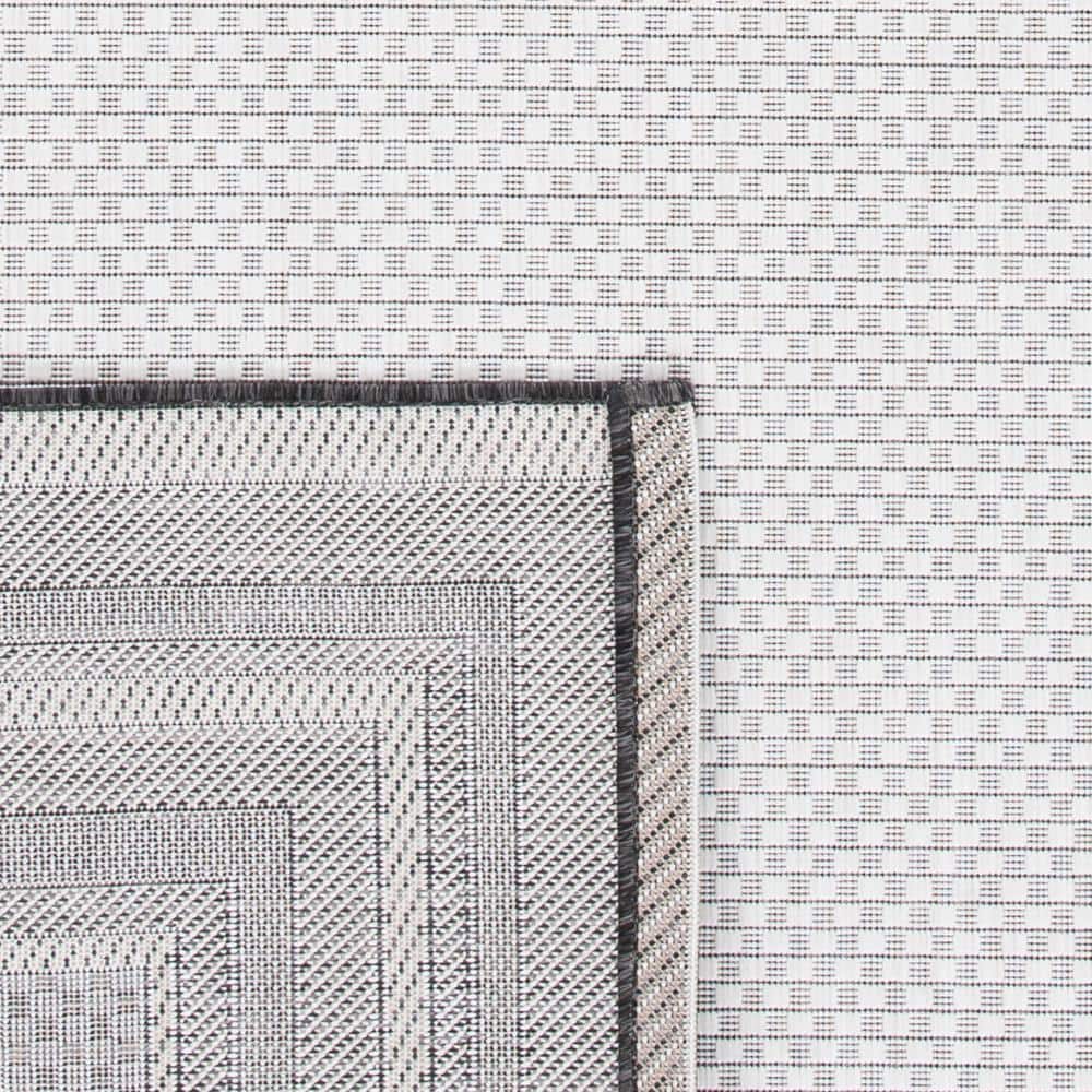 Ivory and Black Reversible Synthetic Indoor/Outdoor Rug