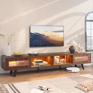 70 in. Mid-century TV Stand Fits TV up to 75 in. with LED Light Ribbed Glass Sliding Door and Open Shelves Walnut