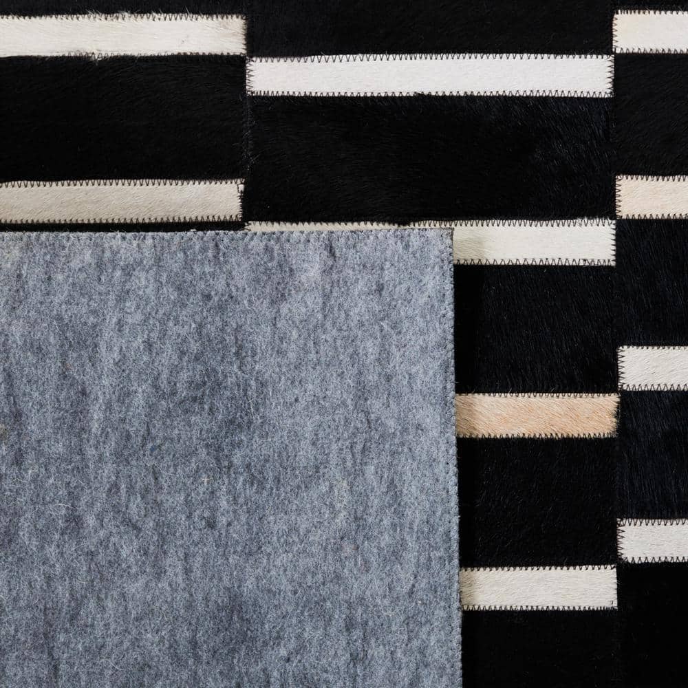Handmade Black and Beige Geometric Cowhide Area Rug