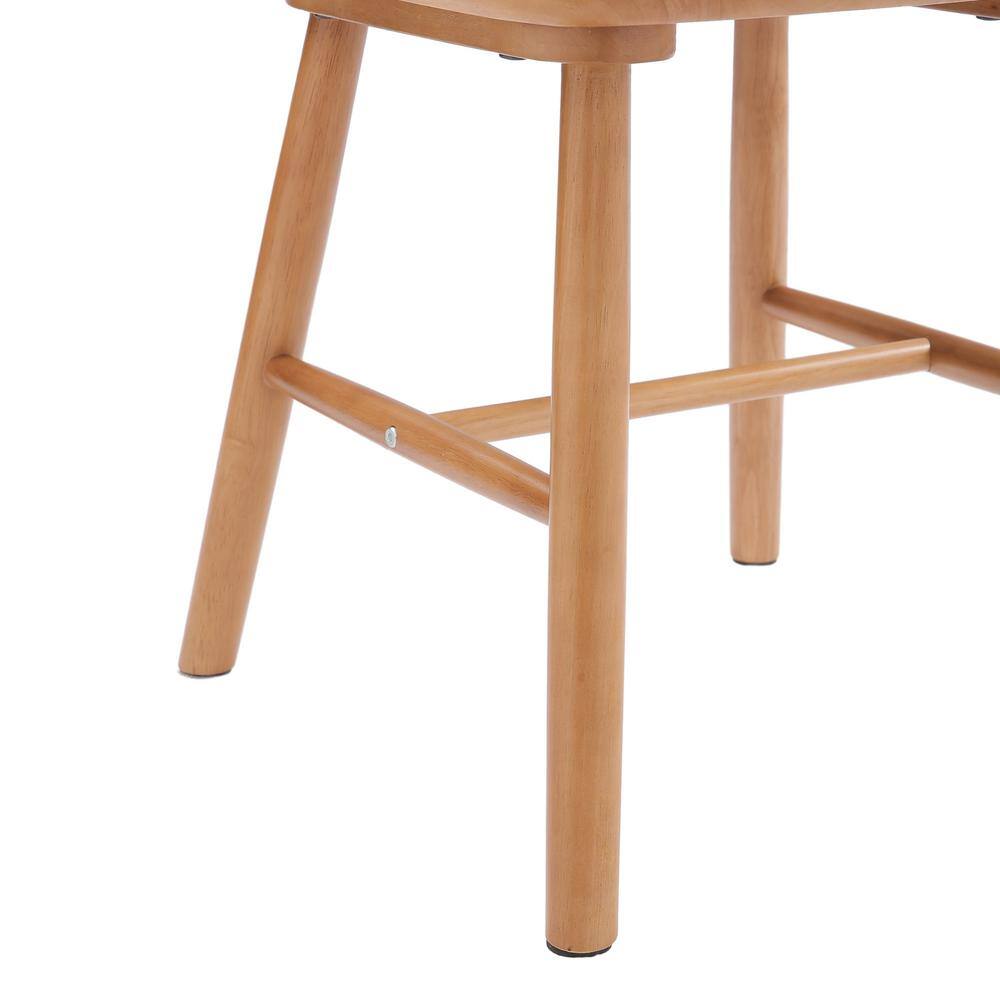 Close-up of the legs and stretchers of a natural wood dining chair.