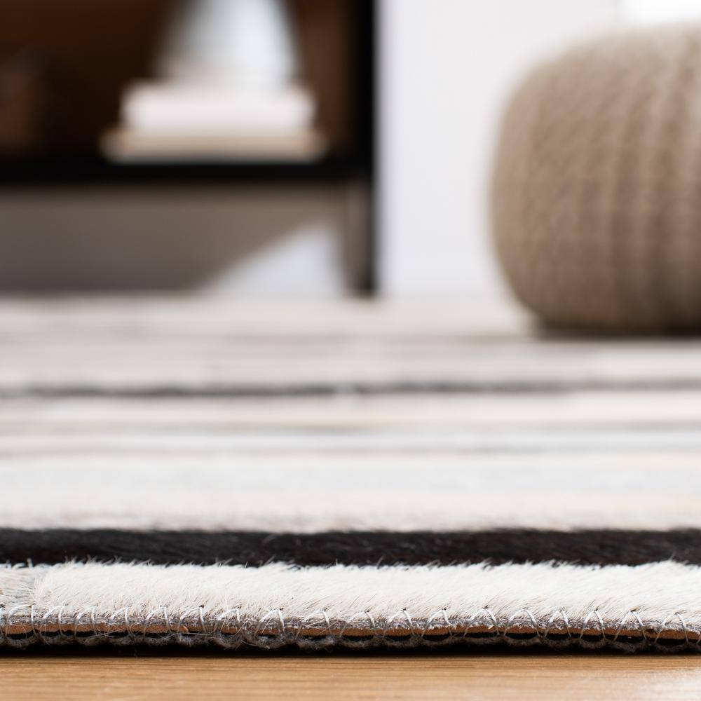 Handmade Black and Ivory Geometric Cowhide Area Rug