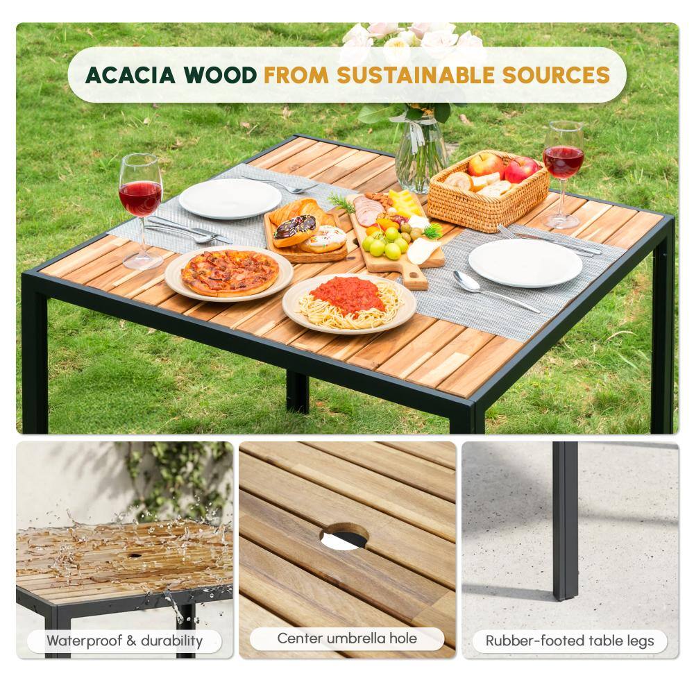Acacia wood table set outdoors with food and drinks.