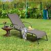 Grey chaise lounge placed on grass with a throw blanket.