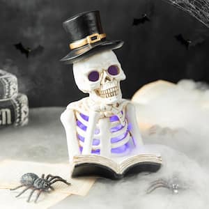 10.25 in. H Halloween Lighted Resin Skull Reading Book Table Decor