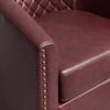 Close-up of red faux leather chair with gold nailhead trim.