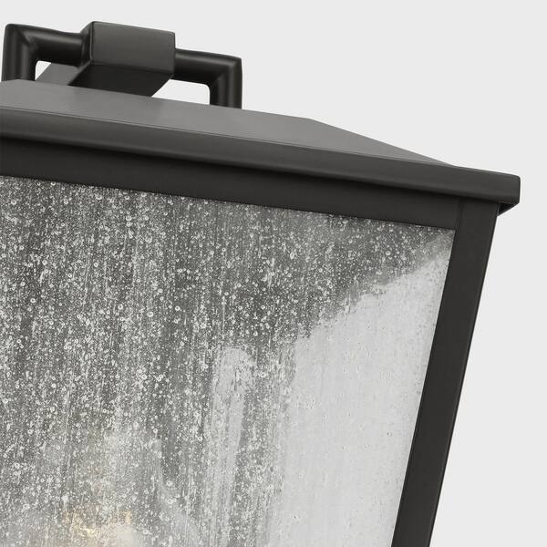 SCOTT LIVING - Kennewick 6.5 in. W x 10 in. H 1-Light Antique Bronze Outdoor Wall Lantern with Distressed Seeded Glass Shade