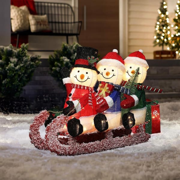 LuxenHome 29 in. Lighted Snowman Family on Sled in Winter Coats
