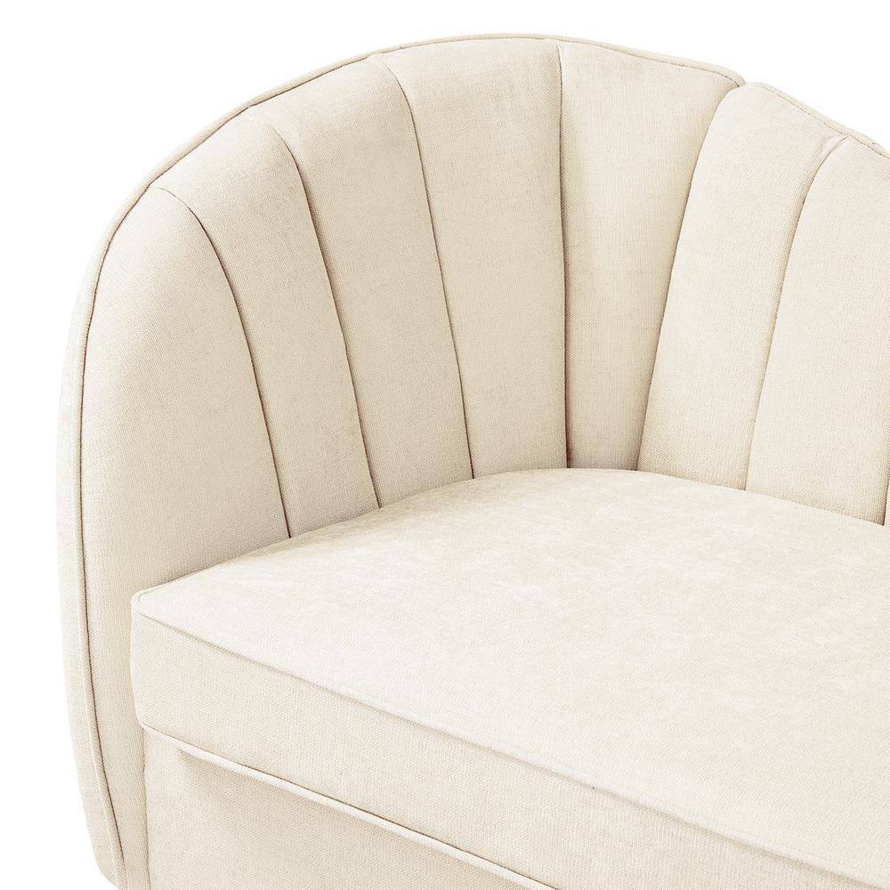 Close-up of the curved arm and channeled back of the beige loveseat.