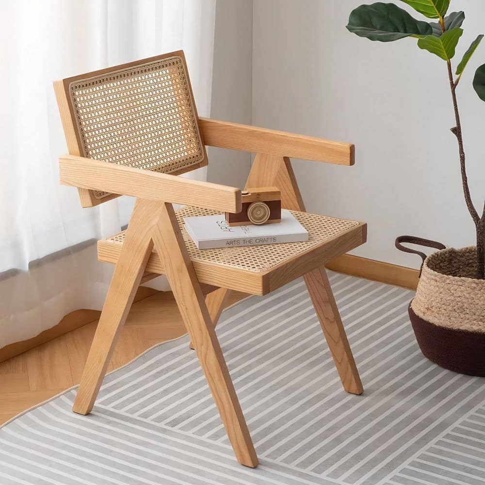 Two wooden outdoor dining chairs with plants.