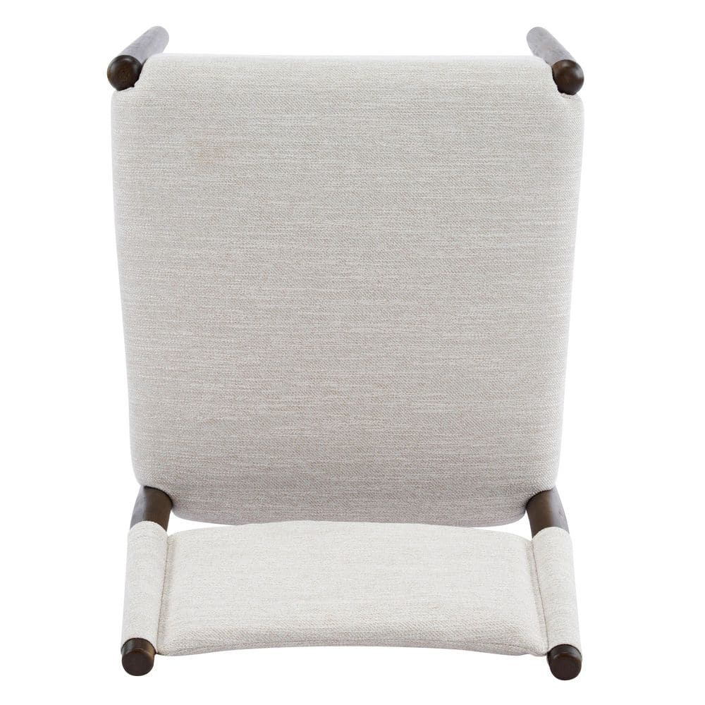 Top-down view of a beige upholstered dining chair backrest and seat.