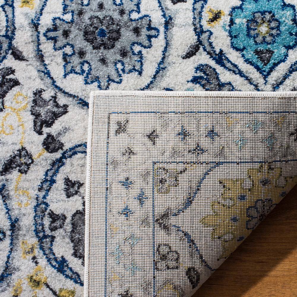 Ivory and Blue Reversible Synthetic Area Rug, 6'7" x 9'