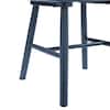 Close-up of the wooden spindle back and legs of a dining chair.