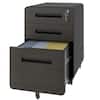 Black metal vertical file cabinet with one drawer open showing folders.