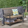 Zeus & Ruta 2-person grey and black acacia wood outdoor bench with shelf in a garden setting