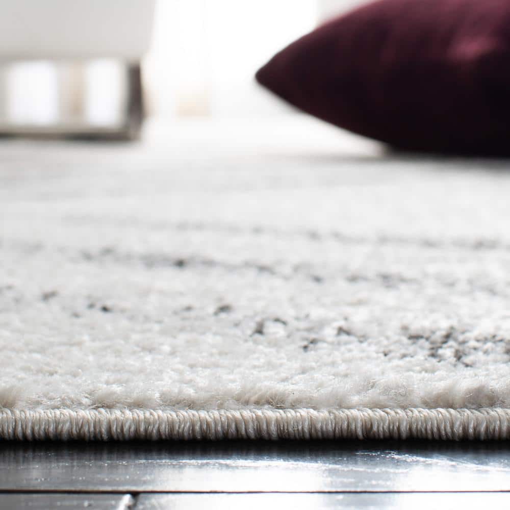 Ivory and Grey Geometric 8' x 10' Synthetic Area Rug