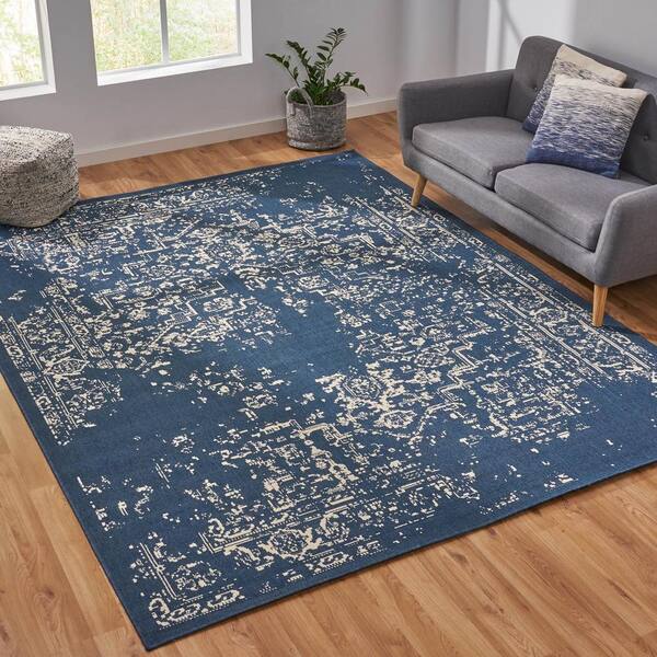 https://images.thdstatic.com/productImages/28eabd99-013f-4a0d-996f-3e5624d787f1/svn/blue-ivory-10-ft-noble-house-outdoor-rugs-106078-1f_600.jpg