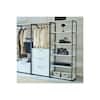 Walk-in closet system with hanging clothes and shelves.