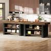 Long kitchen island with a dark wood top and black base featuring multiple open shelves.