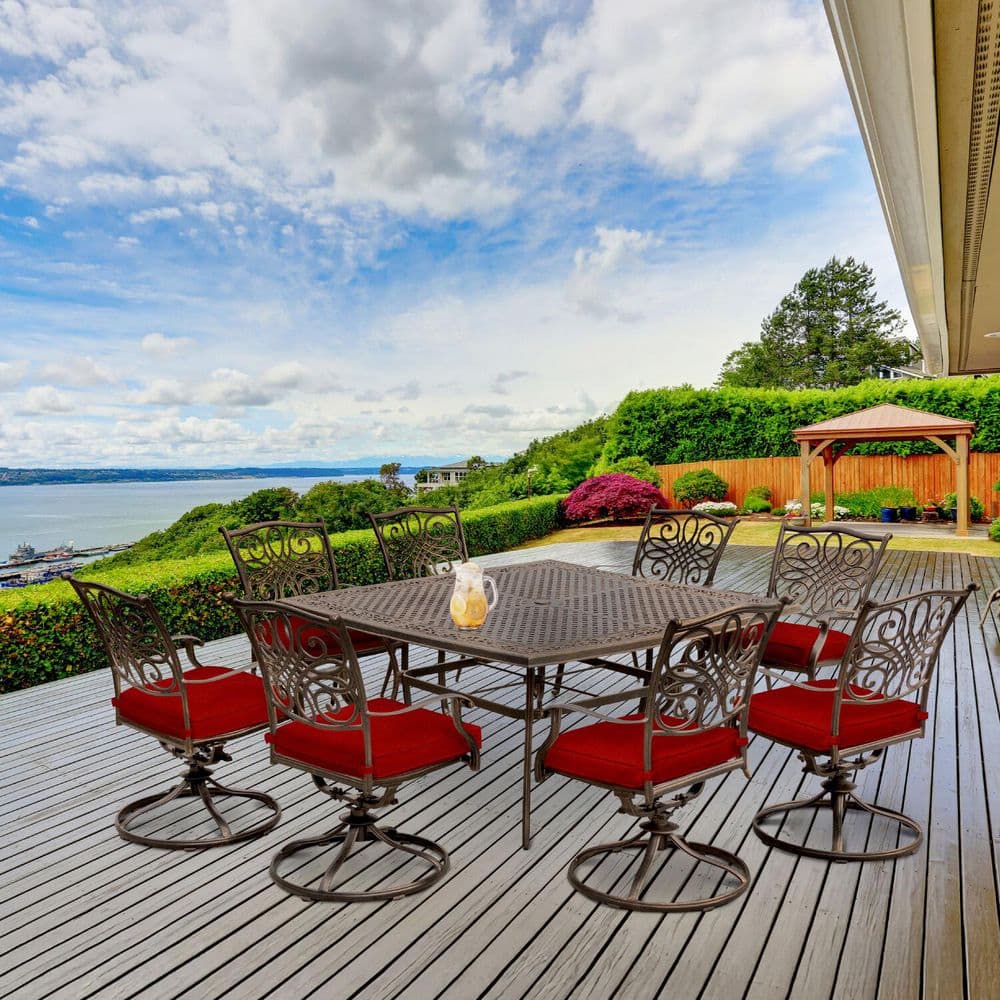 9-piece Traditions outdoor dining set on a wooden deck with an ocean view.