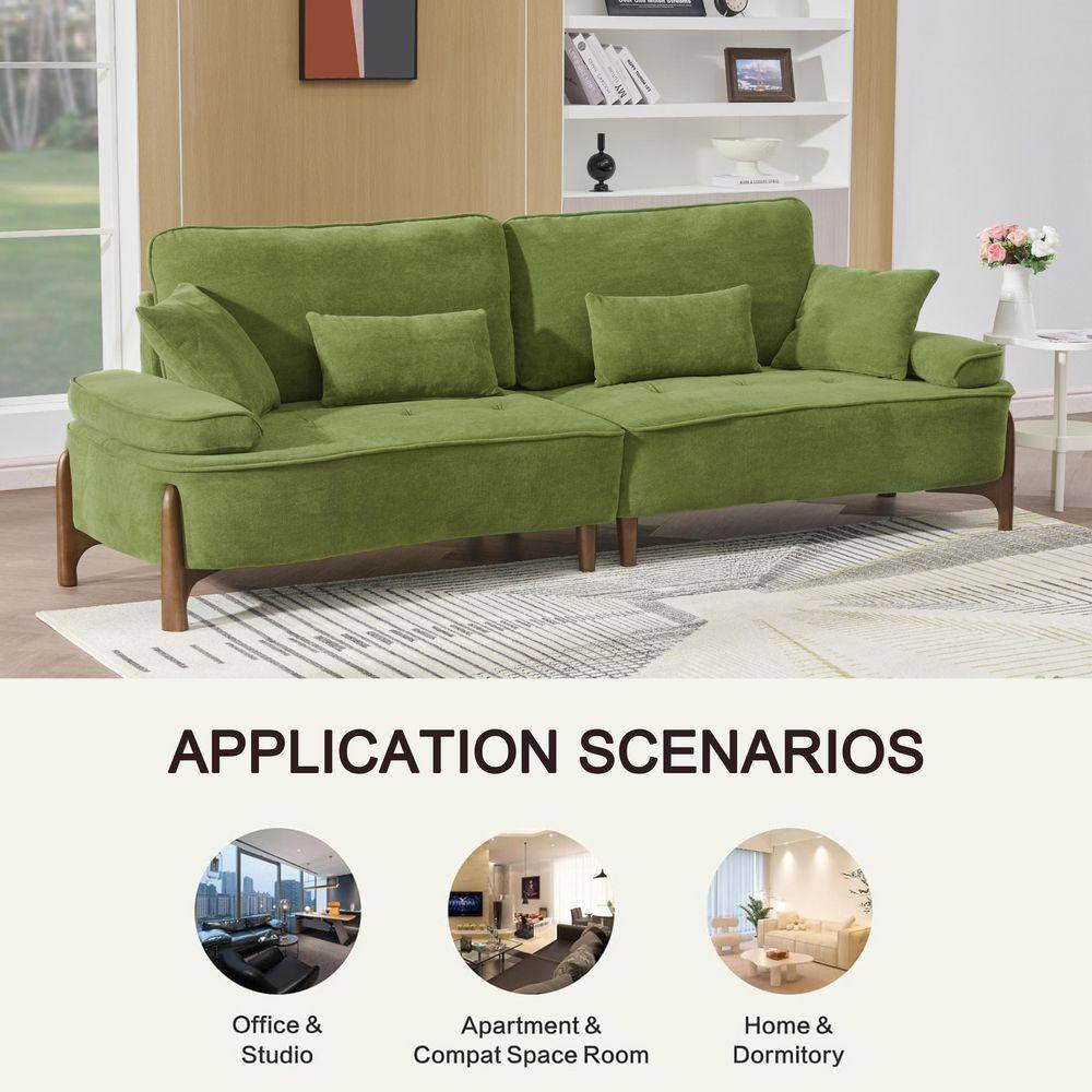 Green velvet futon sofa in a bright living room.