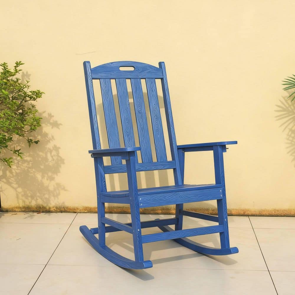 Navy blue rocking chair against a plain wall.