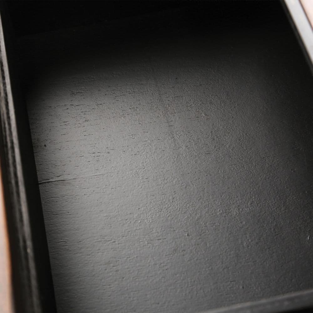 Close-up of the dark interior of the buffet sideboard.