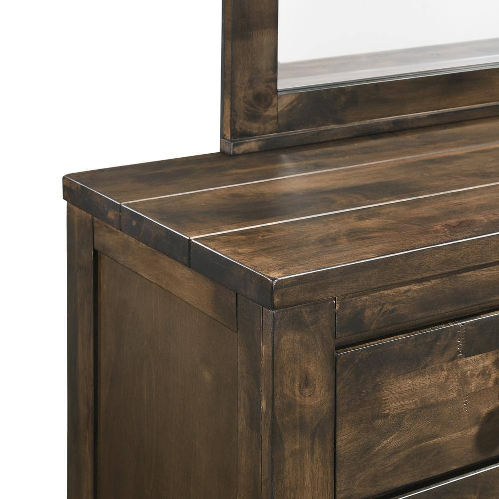 Close-up of the top surface and corner of a rustic gray dresser.