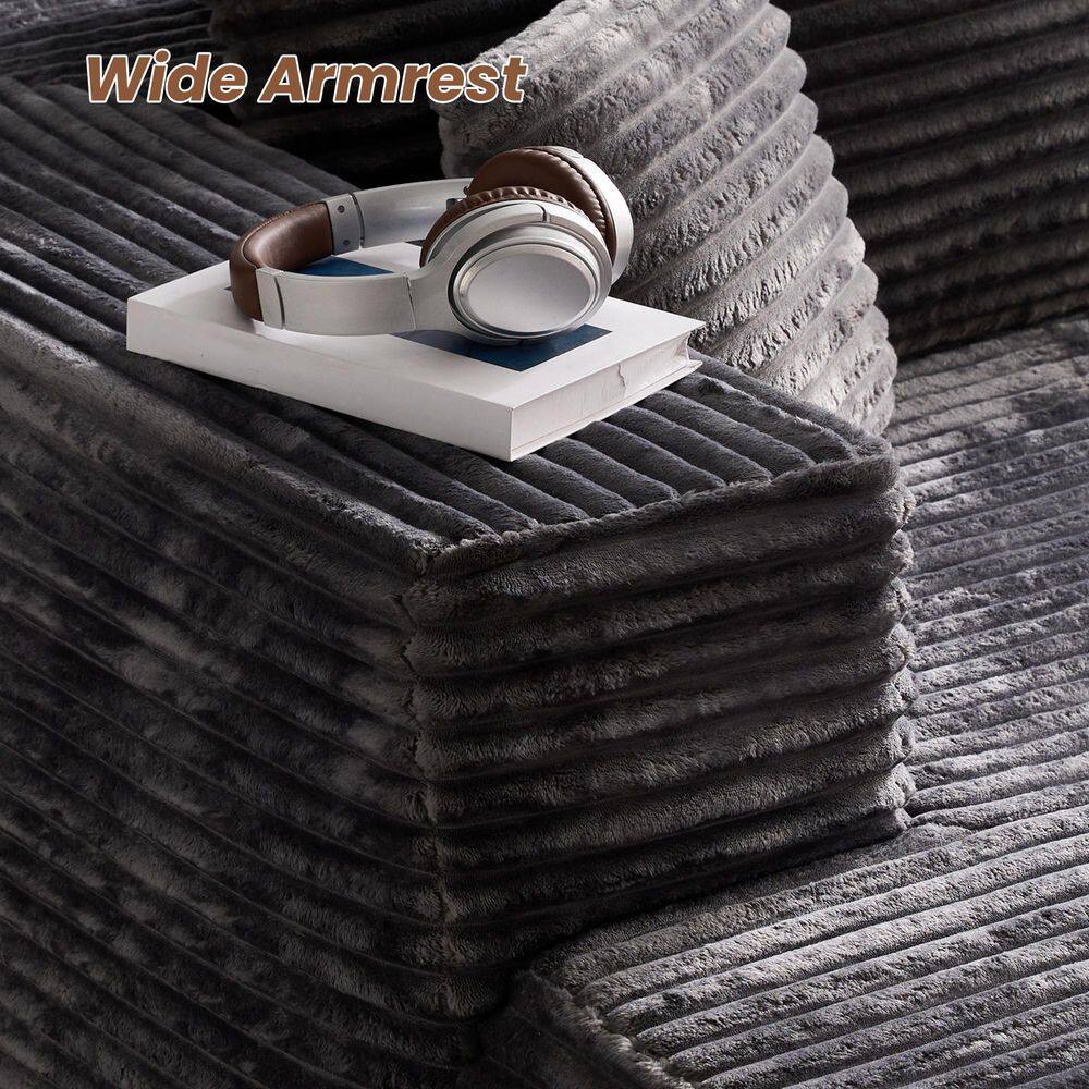 Close-up of the wide armrest of the gray corduroy sofa.