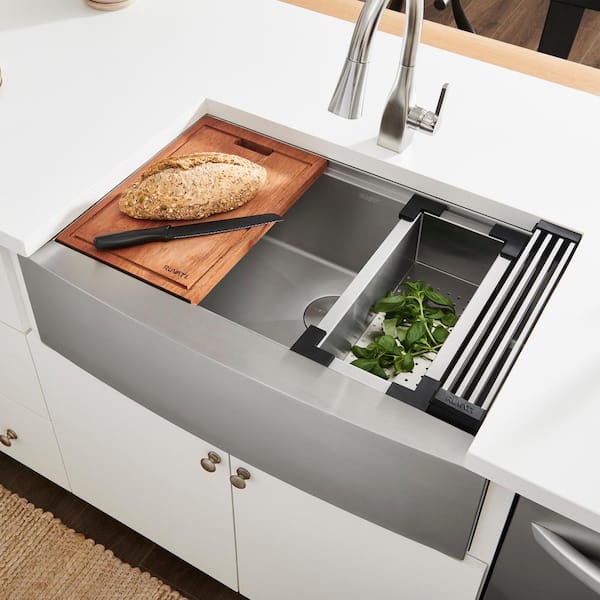 Drain Board built into a granite countertop leading to a bucket sink in a  modern kitchen