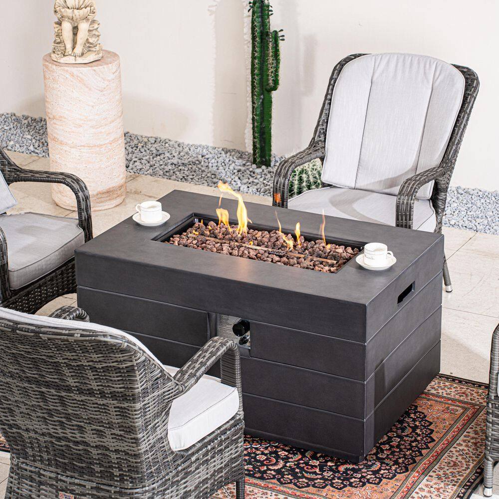 Outdoor wicker fire pit table with seating and fire pit feature.