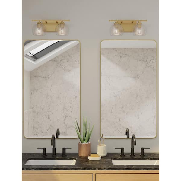 Glint 15.5 in. 2-Light Legacy Brass Vanity Light with Double Clear Seeded Glass Shades
