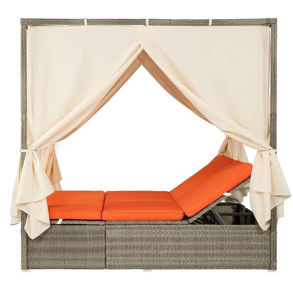 Wicker Outdoor Day Bed with Orange Cushions and Beige Curtain