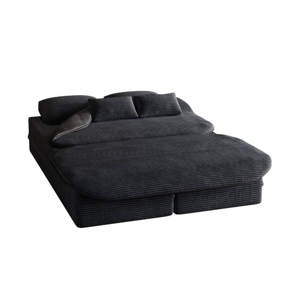 Black corduroy sofa bed unfolded into a flat lounge.