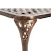 Close-up of the wooden base and carved support of the side table.