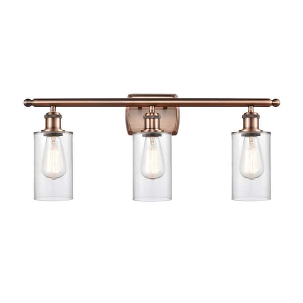 Clymer 26 in. 3-Light Antique Copper Vanity Light with Clear Glass Shade