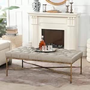 Aerin Warm Gray Faux Leather Hammered Gold Tufted Cocktail Ottoman 25 in. x 48.5 in. x 17.5 in.