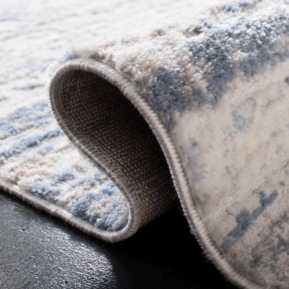 Ivory and Blue Abstract Synthetic Area Rug, 3' x 5'