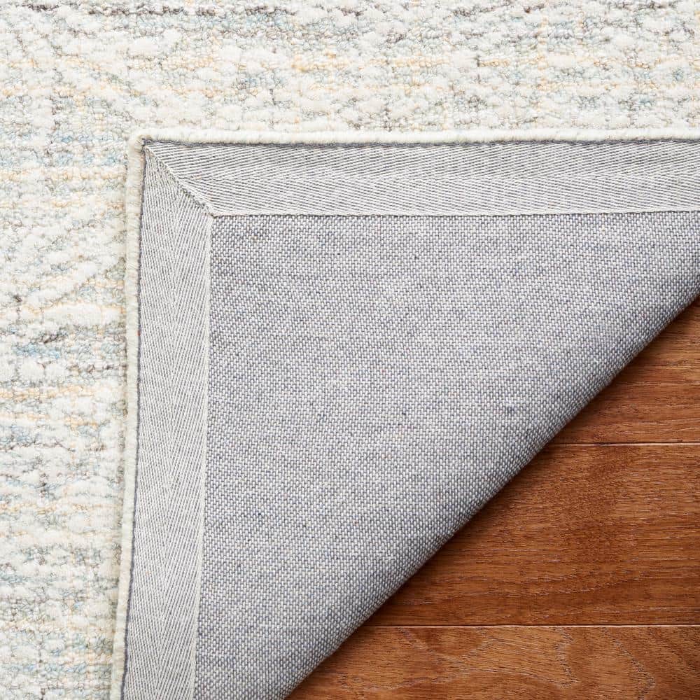 Ivory and Light Blue Tufted Wool 4' x 6' Area Rug
