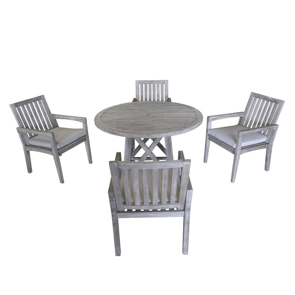 Outdoor dining set with round table and four teak chairs
