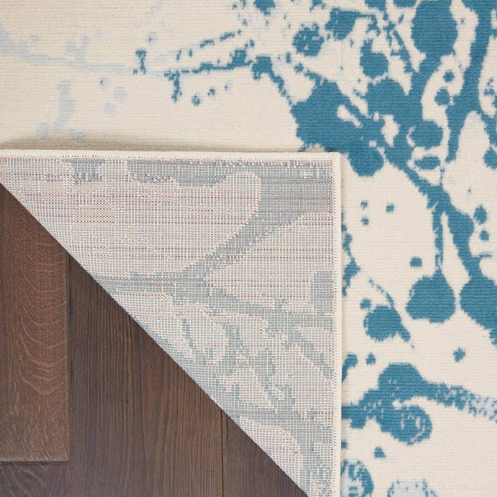 Ivory and Blue Abstract Synthetic 4' x 6' Easy-Care Area Rug