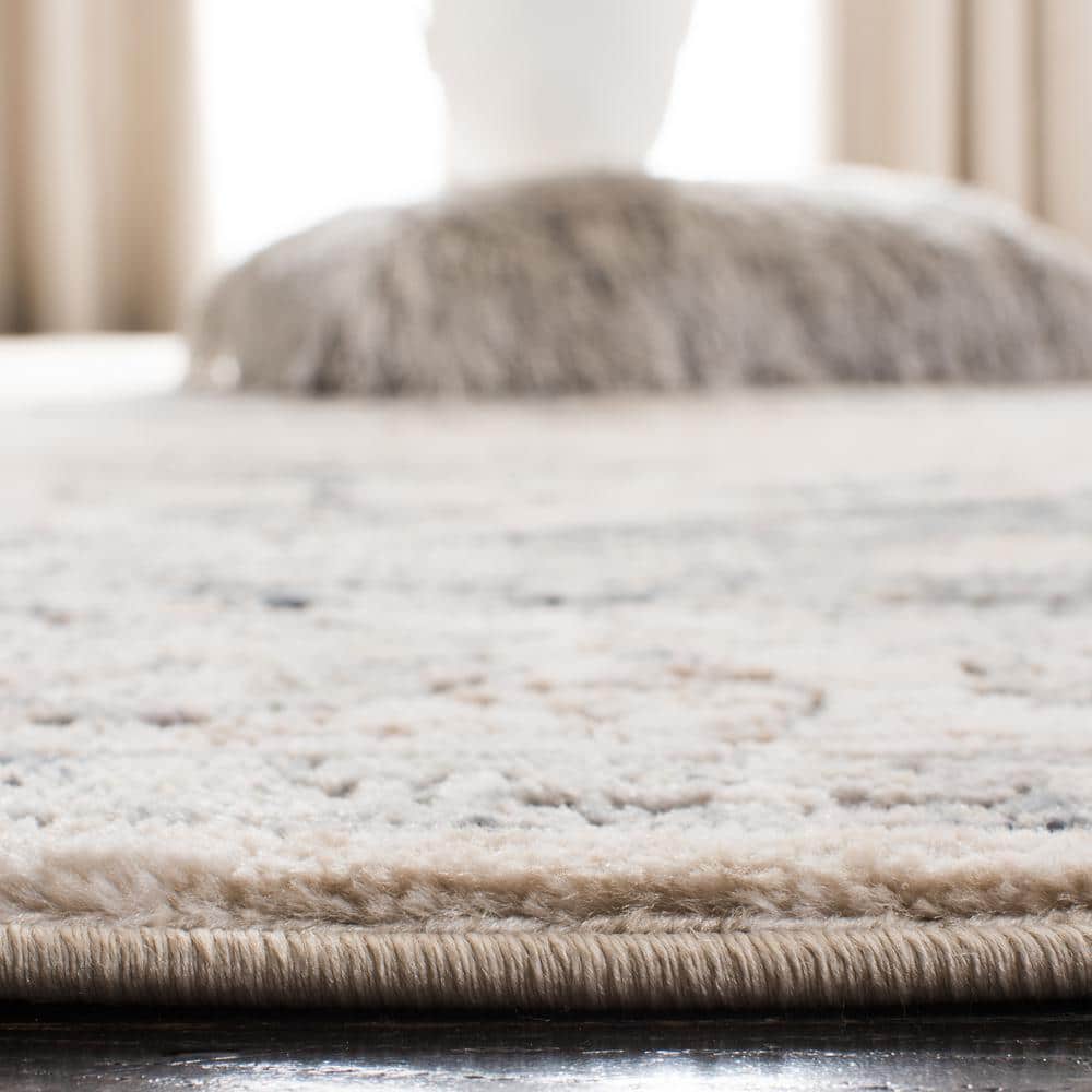 Ivory and Blue Floral Medallion 9' x 12' Synthetic Area Rug